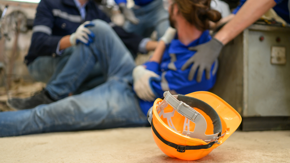 Injured construction worker being assisted after workplace accident in Florida